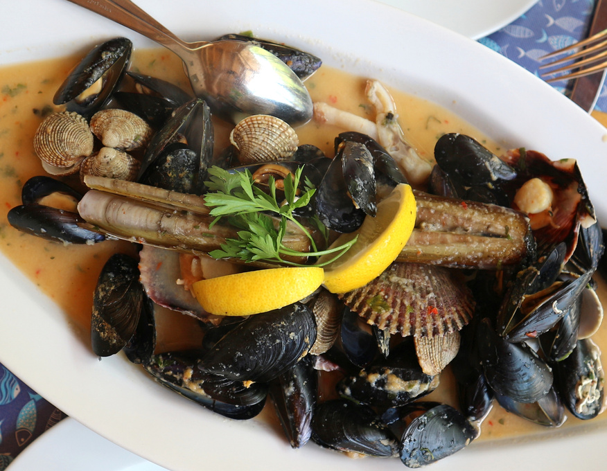 Sauté of seafood with mussels, clams, razor clams and queen scallops in white wine sauce